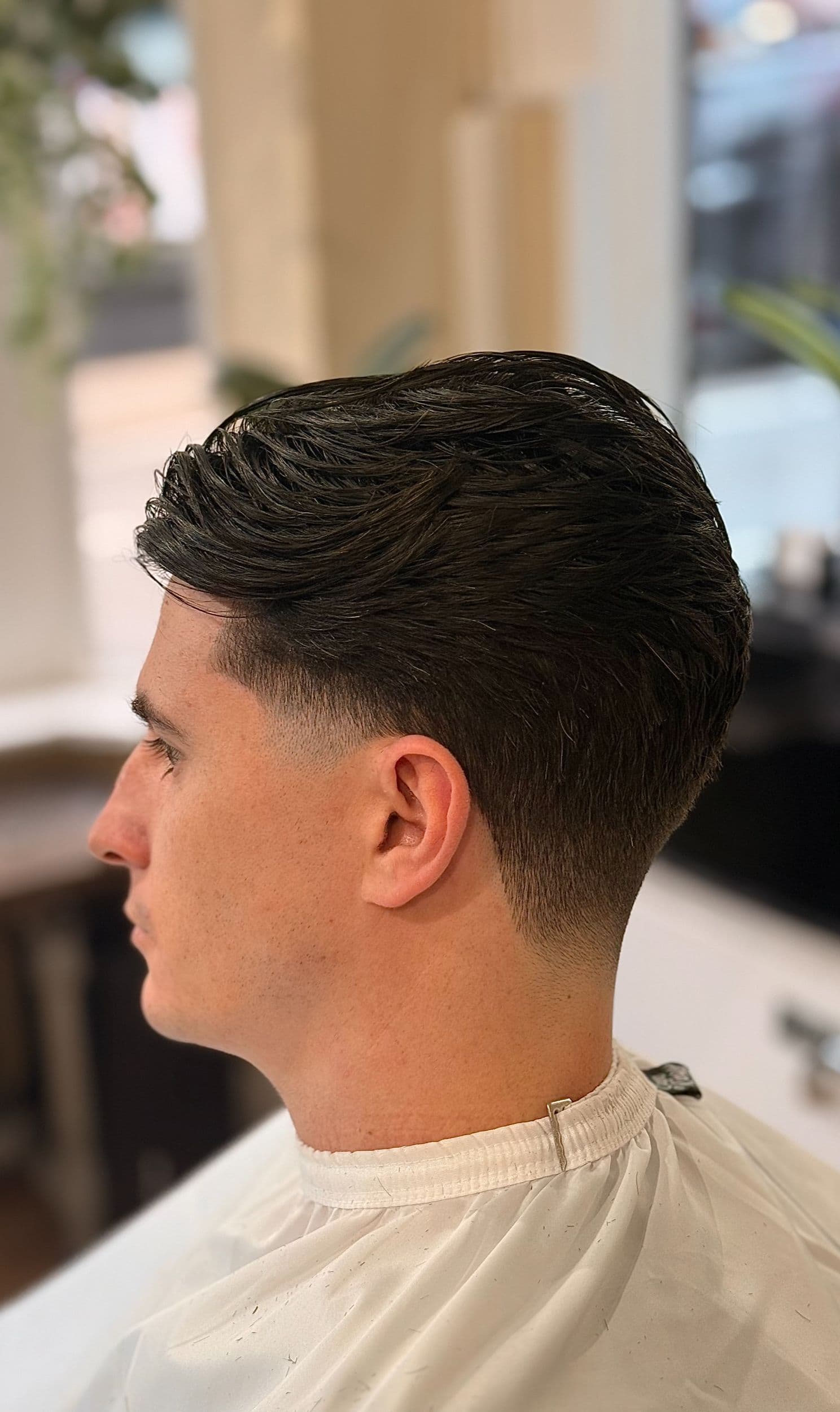 Side profile haircut detail in the chair